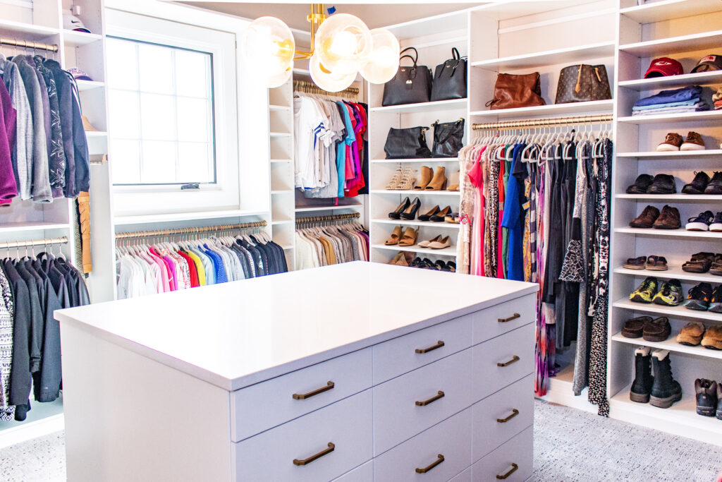 Professionally organized closet with huggable hangers and gold accents by 2B Organized St. Louis.