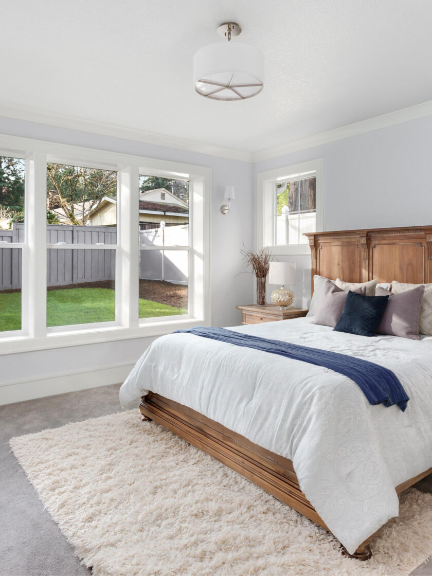 Photo of a beautifully designed and organized guest room by 2B Organized.